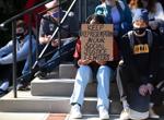 A student holds a sign