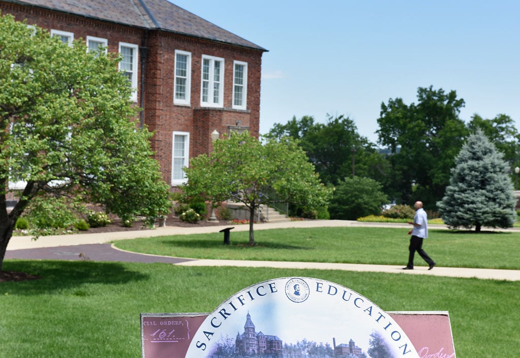 A faculty member walks toward the administration building of Lincoln University