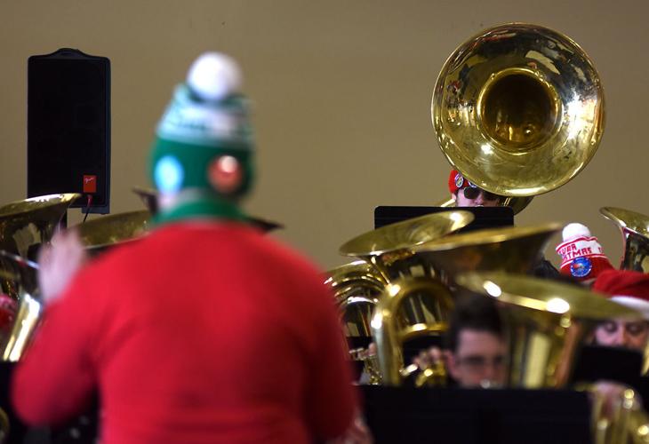 Tuba and euphonium musicians play a series of classic Christmas songs