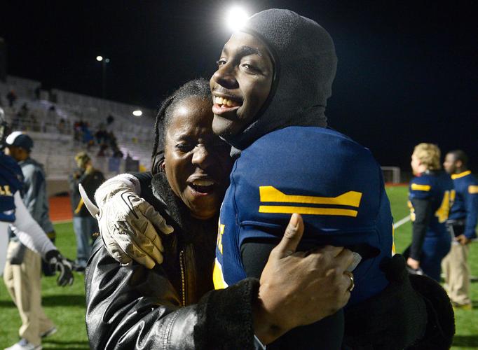 Tasca McHenry-Tolson cries as she hugs her son