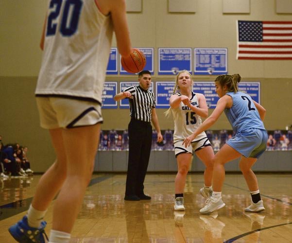 Tolton guard Sophie Angel, center, passes the ball