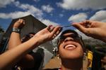 Filipino students view a partial solar eclipse