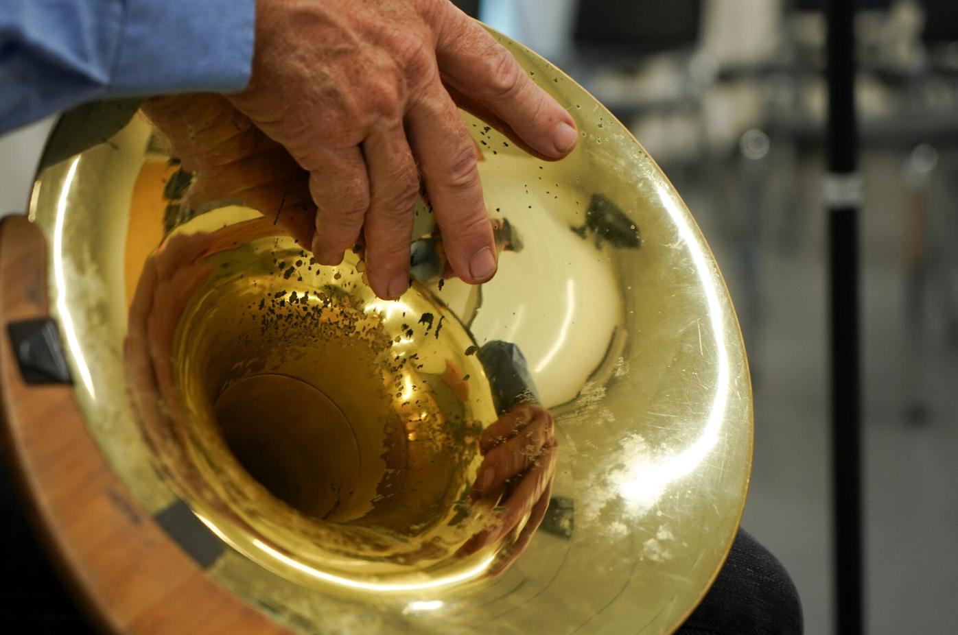 Roger Kaza grips the bell of his French horn