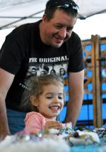 Emaila Santiago admires the products of a booth