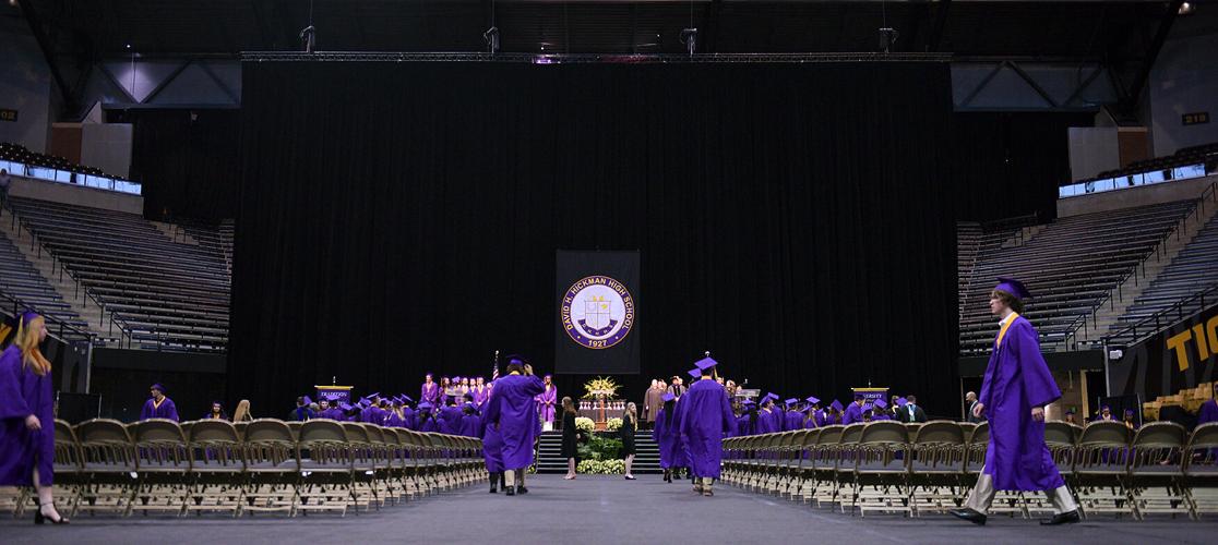 Seniors from Hickman High School walk to their seats