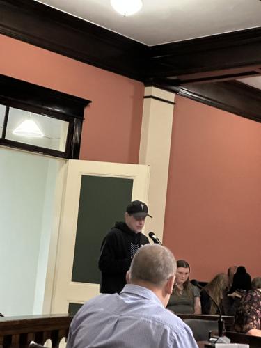 Standing at microphone, Denmark Street resident Nathan Richard