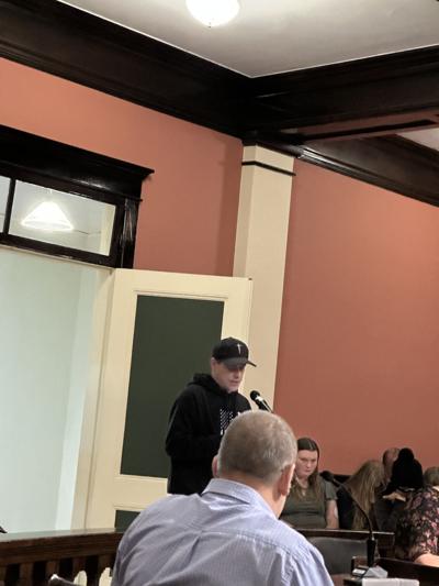 Standing at microphone, Denmark Street resident Nathan Richard