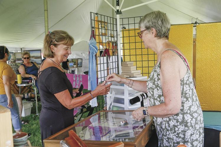 08-06-22 Art in the Park talking with customer medium