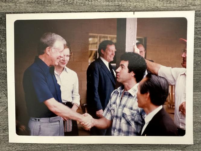 Former President Jimmy Carter (left) shakes the hand of Berlin native Robert Theberge