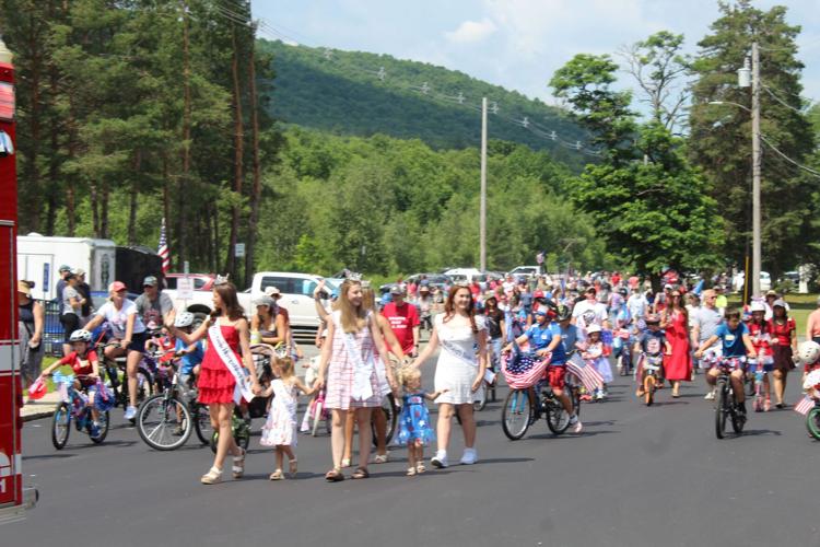 Children and beauty pageant contest winners walk during the kiddie's parade