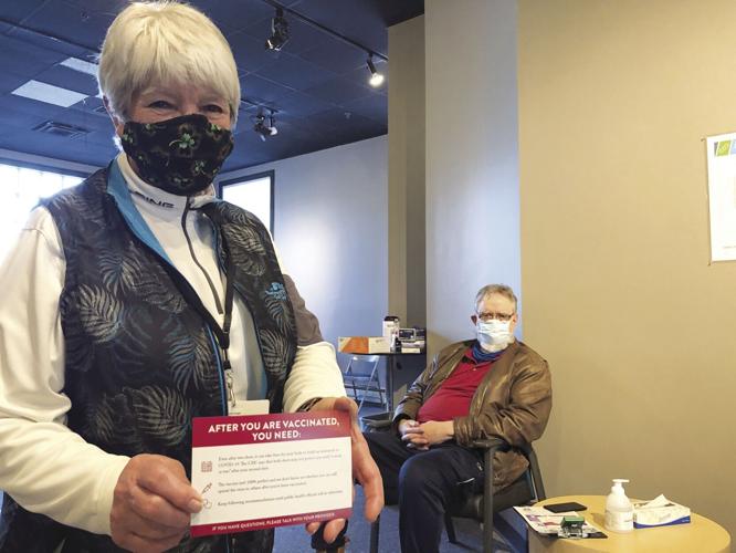 VV - Maryann Lowry displays a COVID-19 card