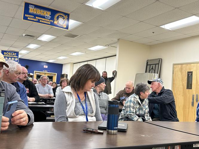 Milan residents listen to questions and answers during the March 4 presentation