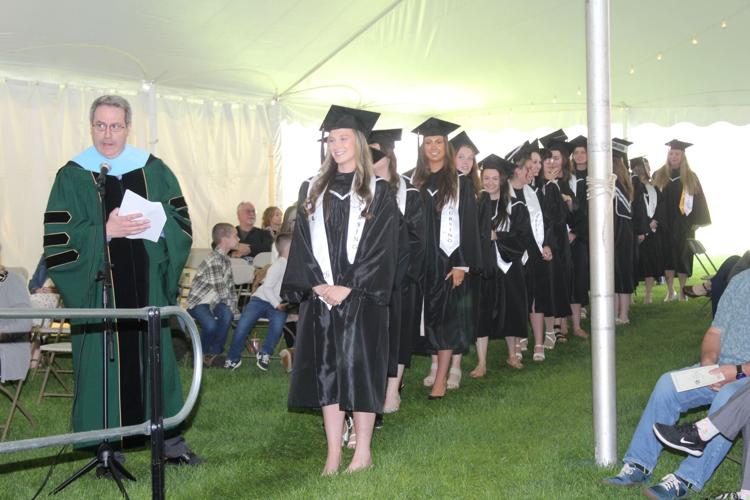 Graduates of the college's nursing programs line up under the tent May 15