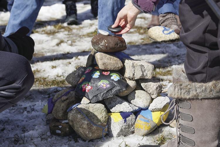 03-13-22 Ukraine Vigil placing stones tight