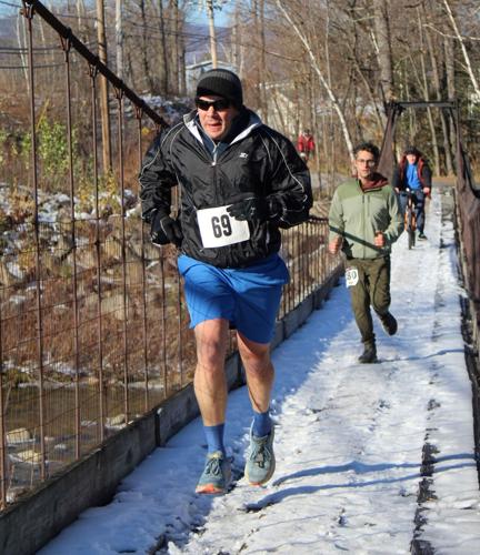 runners on cable bridge in Gorham