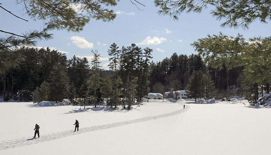 Nordic Tracks - skiers cross the frozen Purity Spring Lake