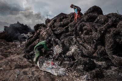 Workers prepare to burn imported plastic waste at a dump in East Java, Indonesia, in 2018.