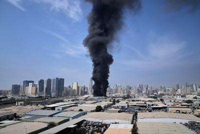 A plume of smoke rises from a warehouse in the industrial area of Sharjah City in the United Arab Emirates, following reports of Iranian strikes elsewhere in the region on March 1, 2026.