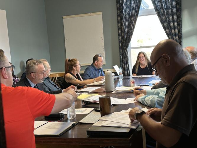 Tammy Fauteux (center at end of table) speaks about the fiscal year 2027 budget to city councilors.