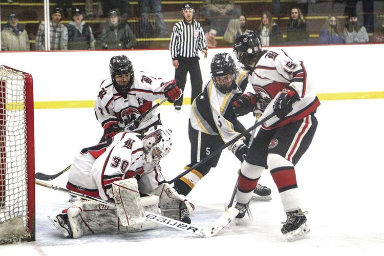 3-5-22 KHS Hockey - Jack Robinson digs for the puck