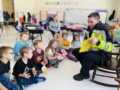 Gorham Police Chief Adam Marsh reading to Ed Fenn first graders