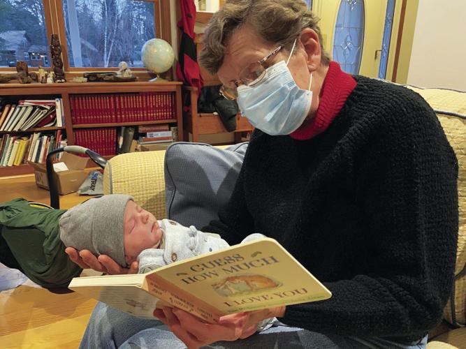 Knirk-Spence - 11 - Cam reads to newborn grandson-2020.jpg