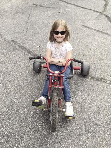 Wheel Family Fun - Juliet Minnich on a big wheel bike