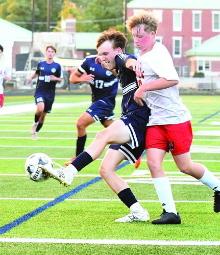 FA Boys Soccer - Jacob Eveleth shields the ball