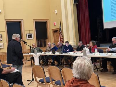 Gorham resident Adam White (standing left) speaks about the cost of police and emergency dispatch services