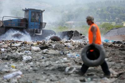 A trash compactor rolls over an active dump site at Pioneer Crossing Landfill in Birdsboro, Pa.