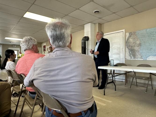 Executive Councilor Joe Kenney (right) speaks about the hangar and contract