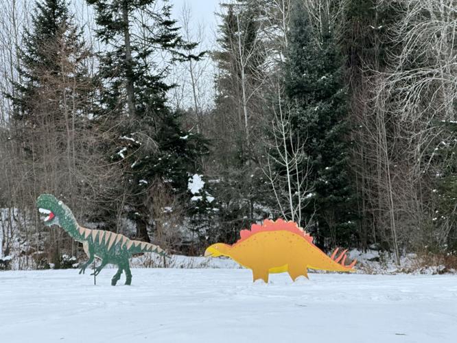 Dinos roam a snow-covered lawn at the Berlin/Milan town line