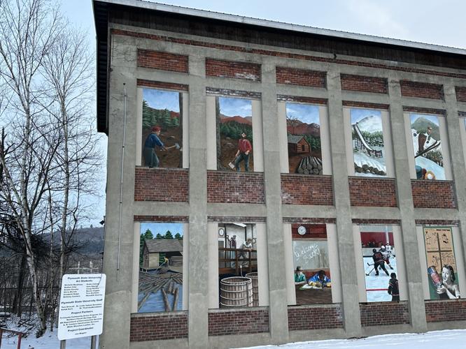 Murals depicting Berlin's industrial and winter sporting history on the Main Street front-facing side