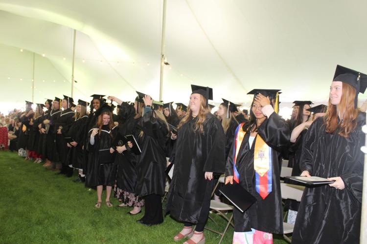 Members of the Class of 2026 prepare to move the tassels from their mortarboards