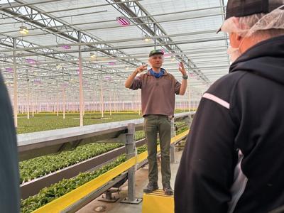 Jack Daley, center, explains the warehouse's workings during an April 2025 tour
