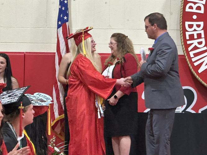 Leigha L. Laflamme (left) shakes the hand of Berlin school board chairman Matt Buteau
