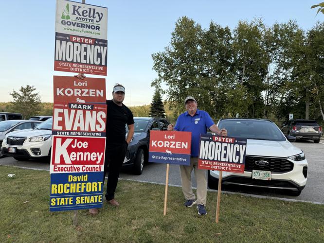 On Tuesday, Sept. 8, Berlin residents Matthew Chernicki (left) and Steven Korzen hold placards
