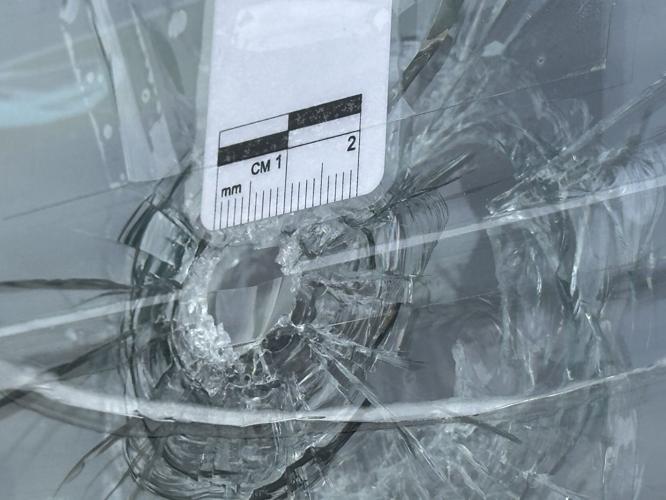 A view of a gunshot damage to a window at the Verizon store at Glen Ave. in Berlin