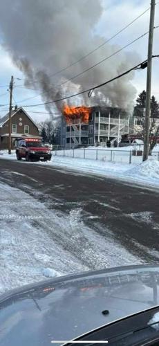 Flames pour from the third floor of 395 Derrah St. in Berlin on Dec. 16