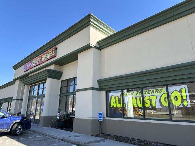Large signs announcing its closing greet shoppers and passersby of Top Furniture
