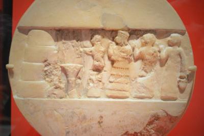 An ancient disk shows the priestess Enheduanna, third figure from the right, during a ritual.