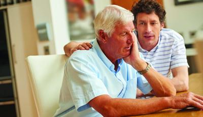 Adult son having a serious conversation with his aging father