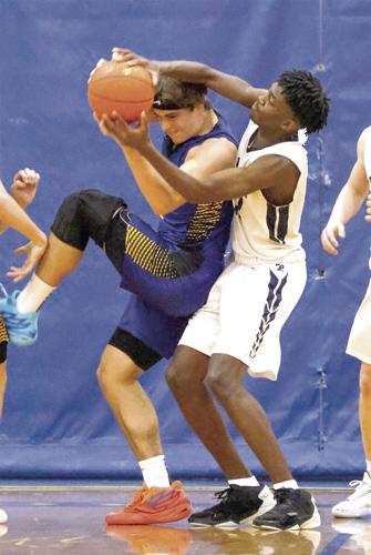 FA boys hoop - Joao Teixeria Orlando wrestles for the ball