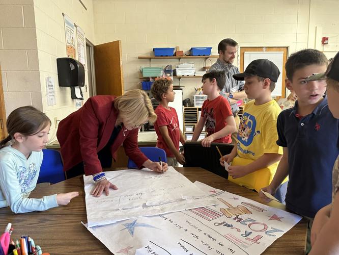 U.S. Sen. Maggie Hassan (D-N.H.) signs student-drawn posters