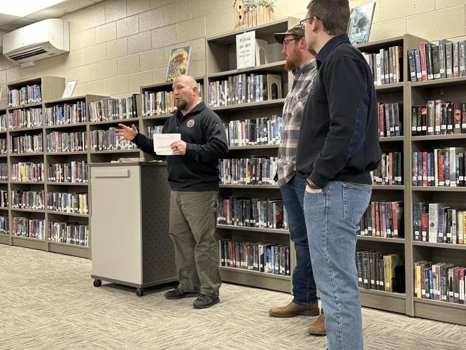 Welding instructor Dennis Cornish (left) explains the welding program