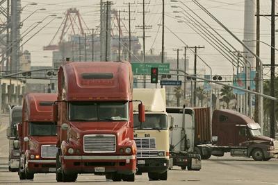 Trucks leave a smoggy Port of Long Beach in 2008, the year before the endangerment finding was released.