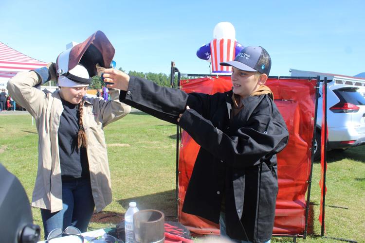 Tess Poitras (left) confers with Brock Theberge about welding as a career