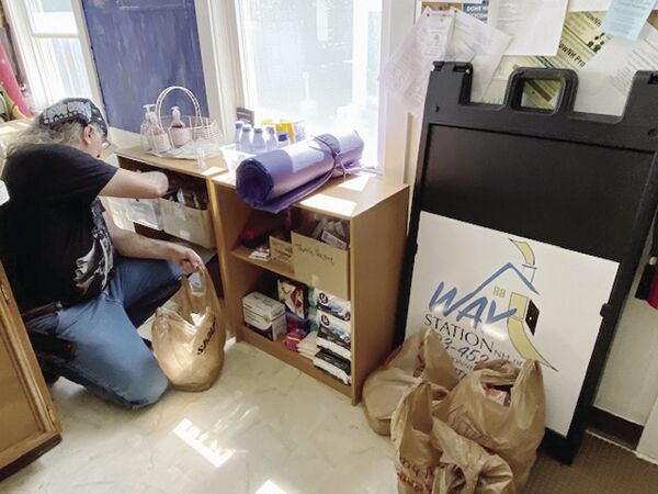 way station sign with making bags