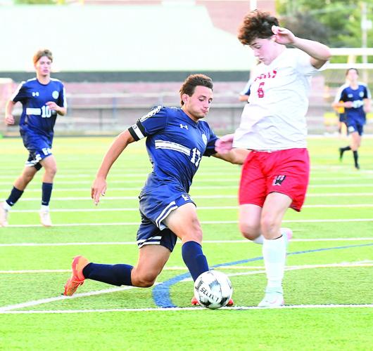 FA Boys Soccer - Tucker Barnaby wins the ball
