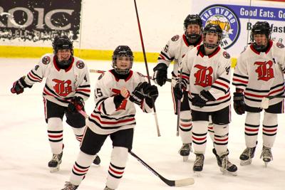 The Berlin-Gorham-Kennett girls hockey team celebrate Jan. 7